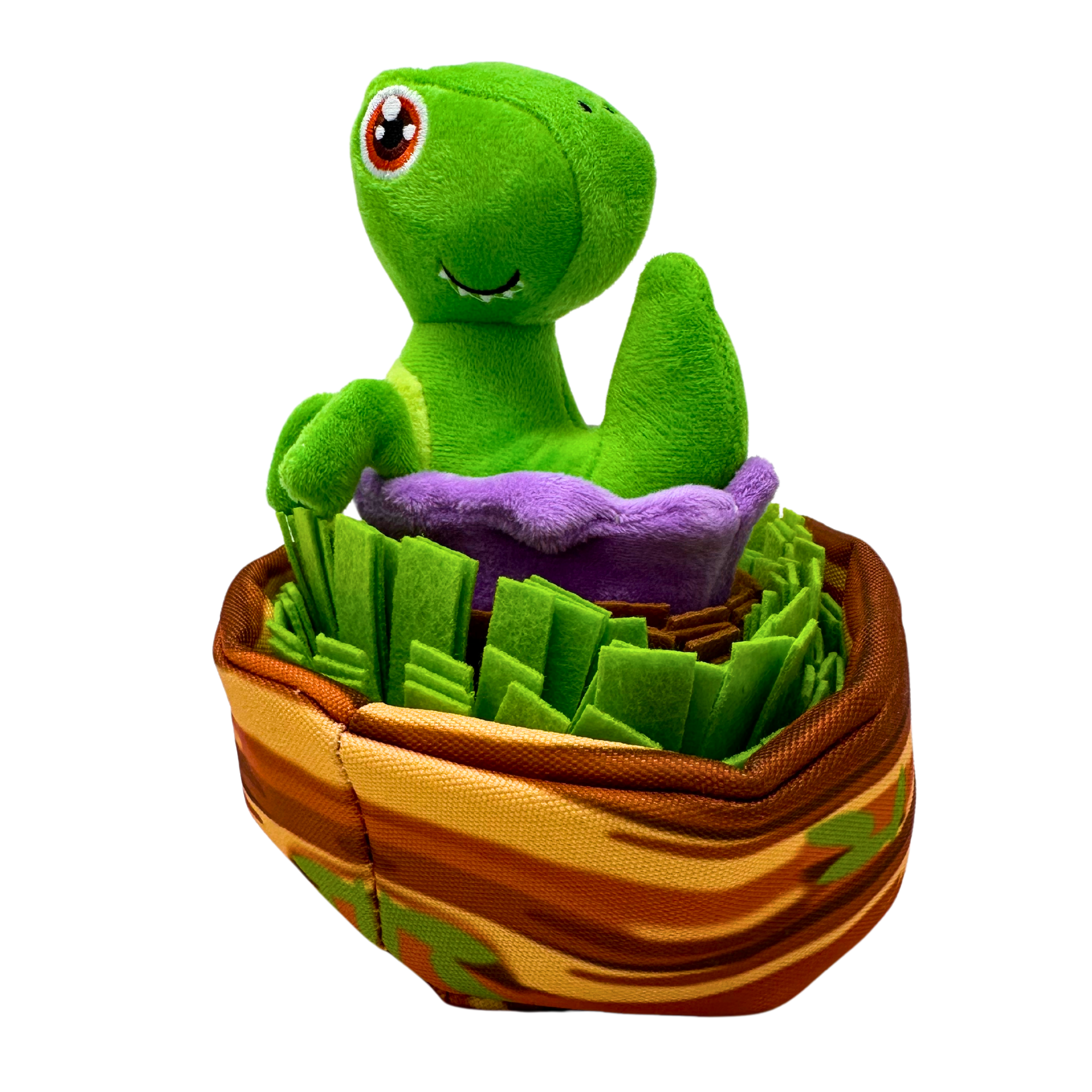 Plush green dinosaur with large eyes sitting in a purple egg-like pod placed inside a nest with layered fleece flaps