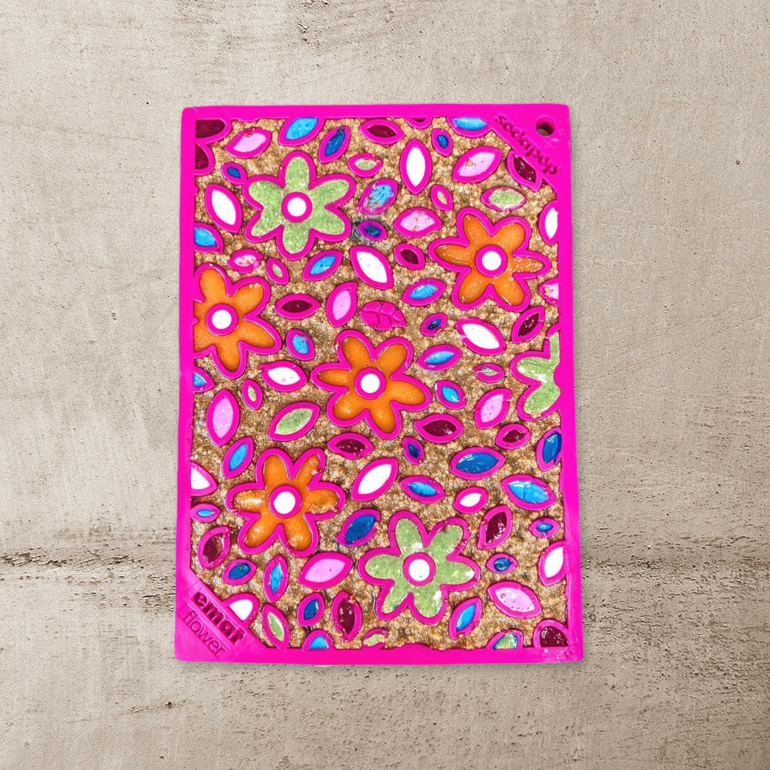 Small pink Flower Power lick mat covered in colourful treats