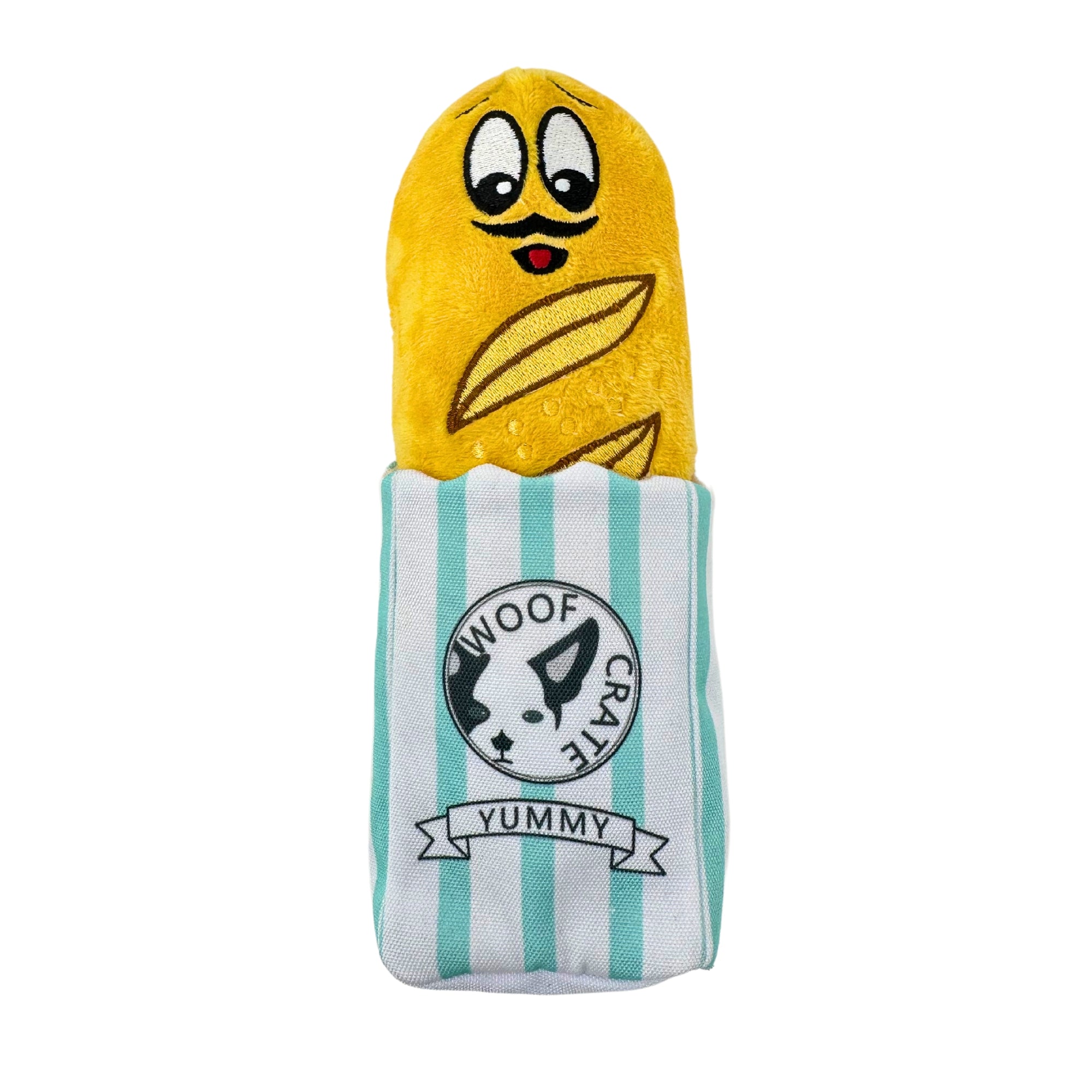 Plush baguette dog toy with a mustached face, peeking out of striped WoofCrate sleeve labeled “Yummy”