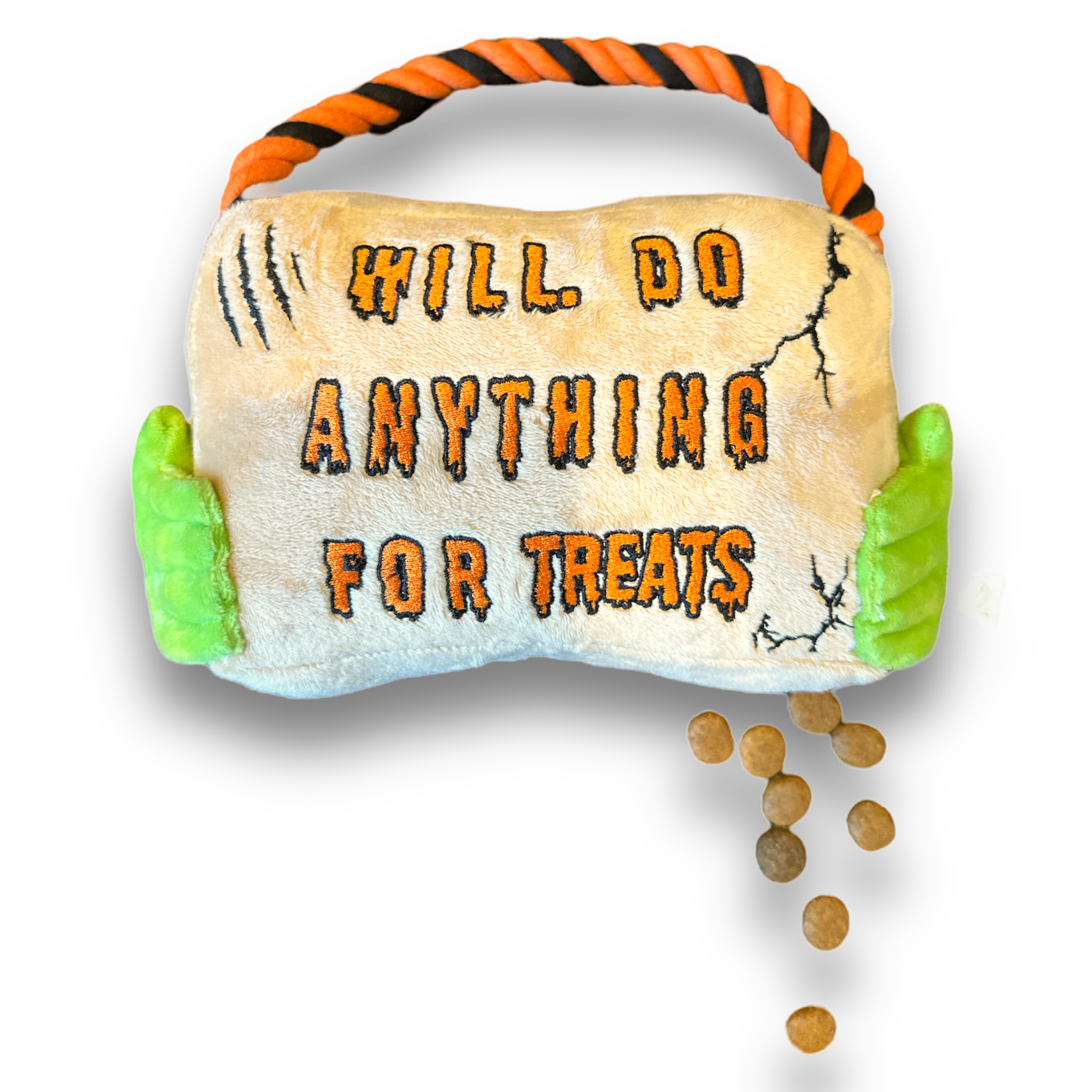 A halloween themed plush dog toy that resembles a sign with a rope. Green hands hold the sign and the sign reads "Will Do Anything For Treats".
