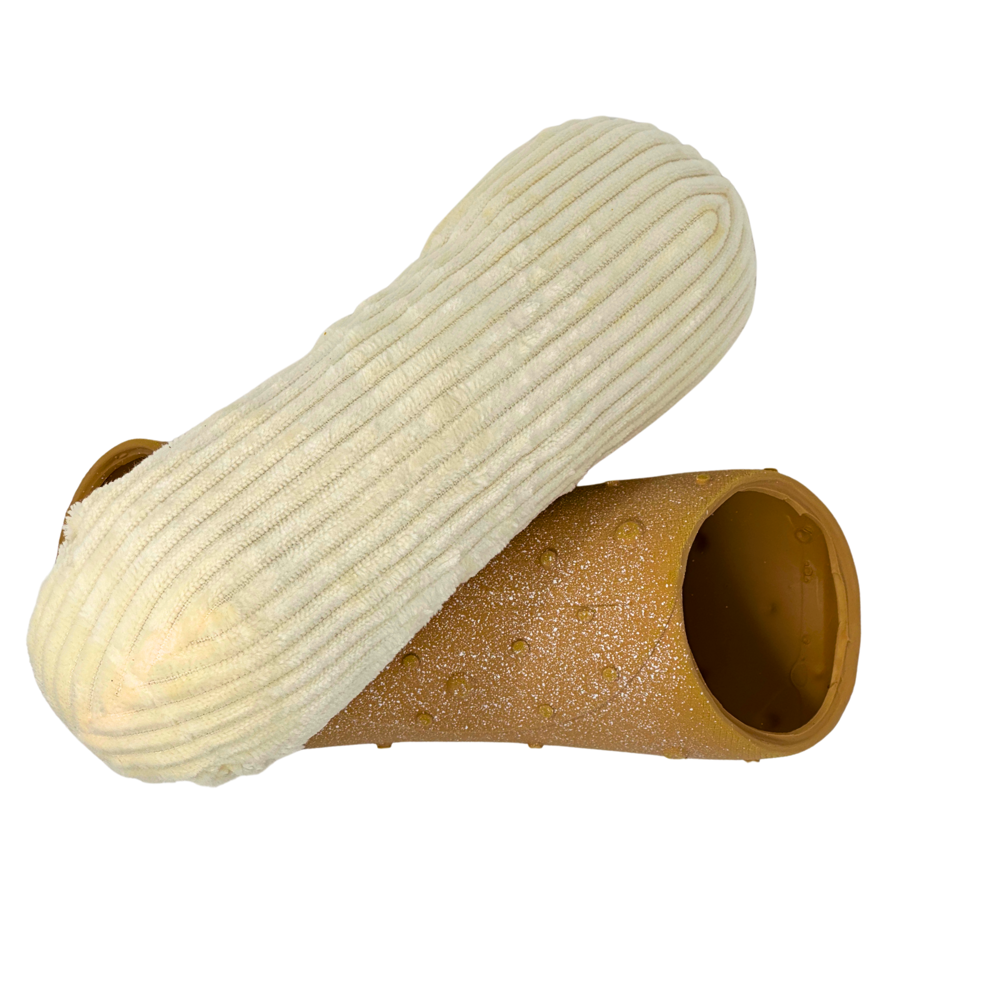Disassembled plush cannoli dog toy showing soft ribbed stuffing and hollow brown outer shell