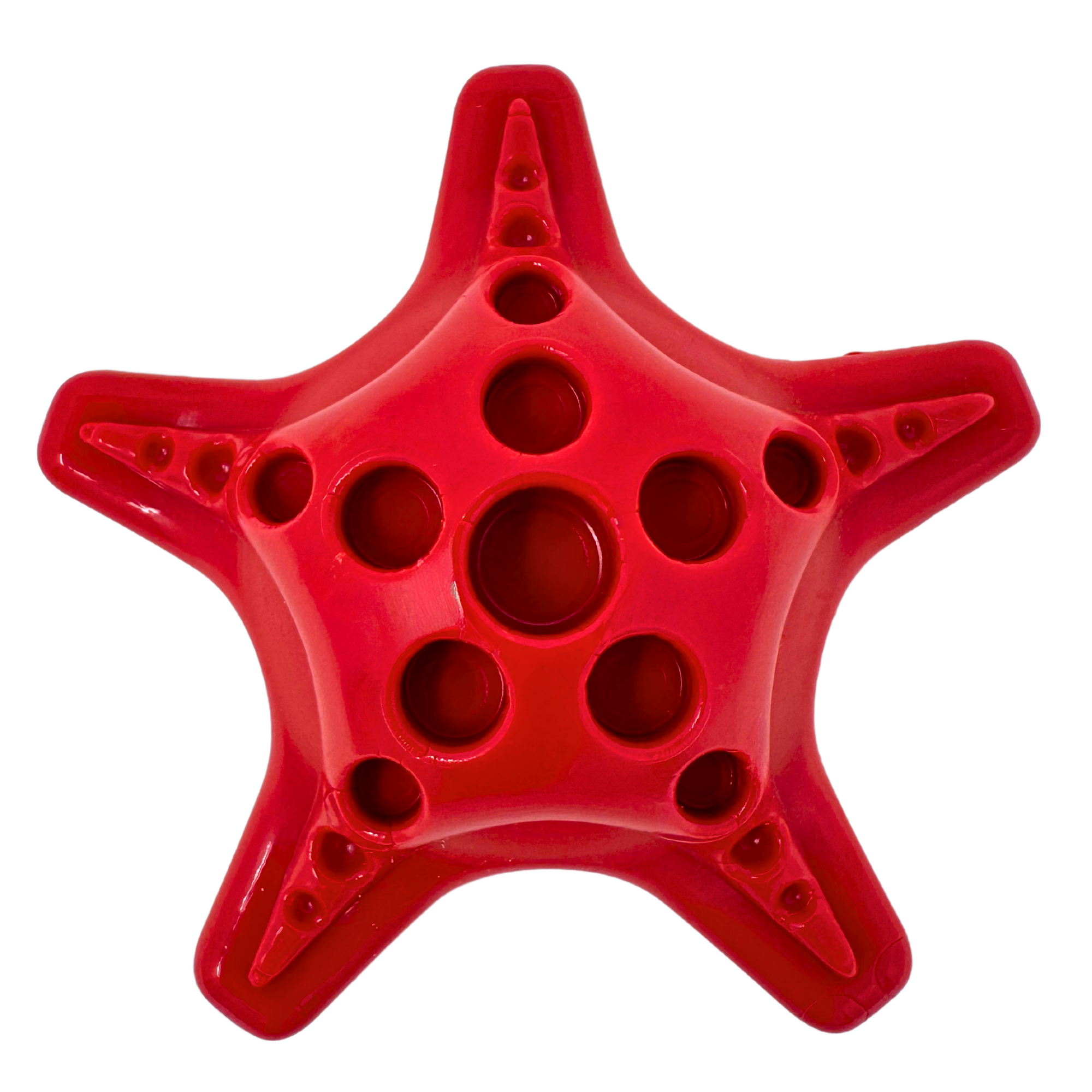 Star-shaped red dog toy with raised edges and varied hole sizes