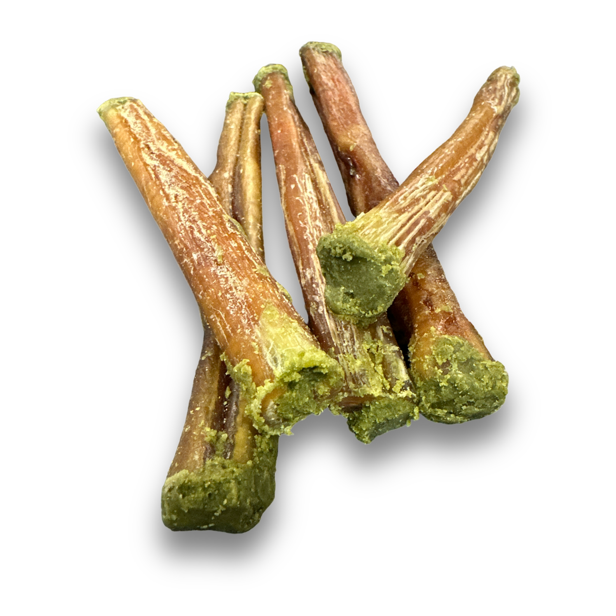 Bully sticks with green super greens stuffed ends on a white background