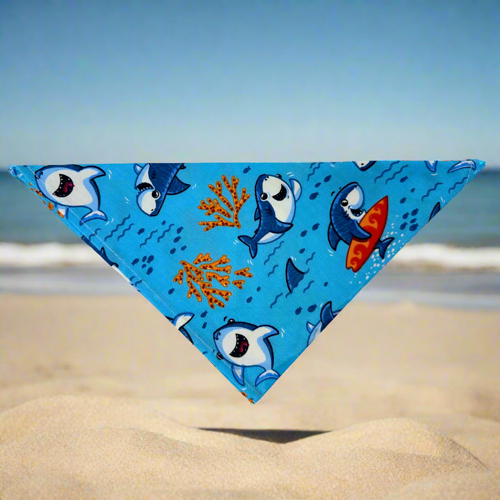 Triangle dog bandana with surfing shark and underwater coral print in blue and orange tones
