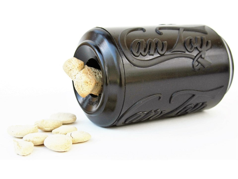 Black SodaPup Magnum Can Toy lying on its side with treats spilling from the opening