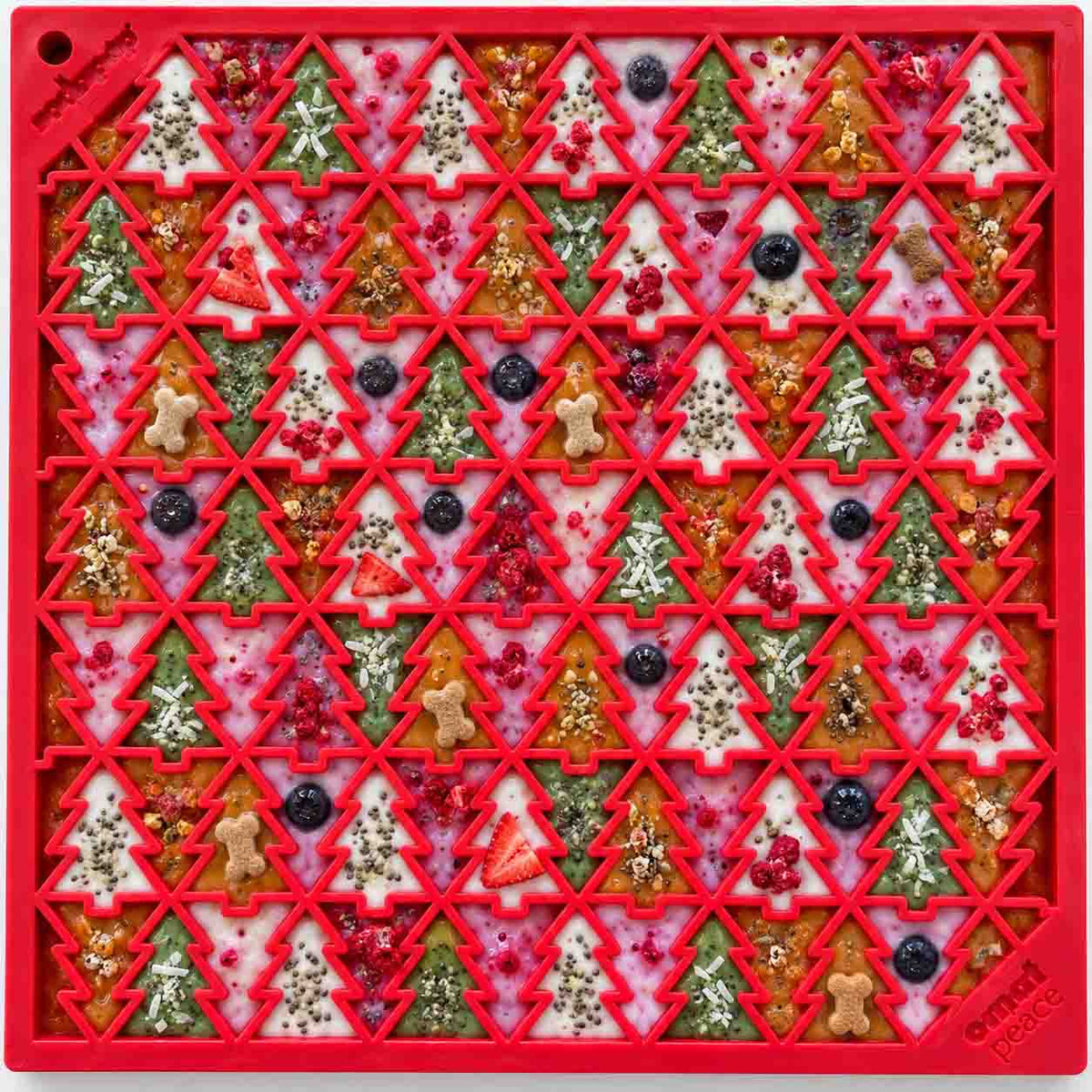 Red Christmas Tree lick mat covered in colourful treats