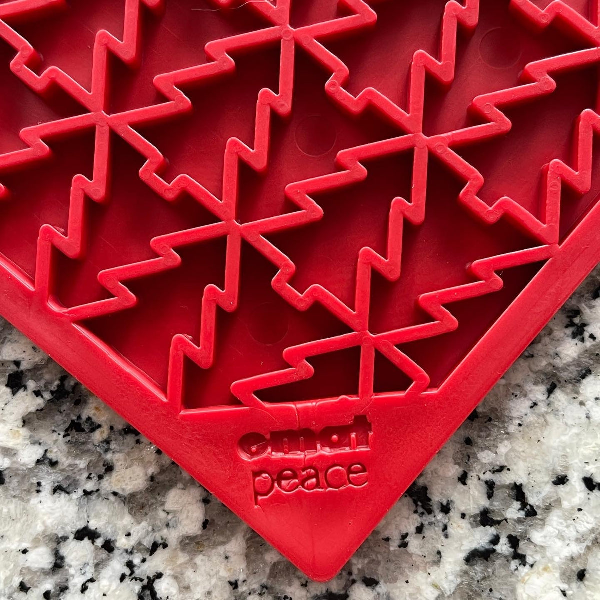 Angled close-up of the red Christmas Tree lick mat pattern