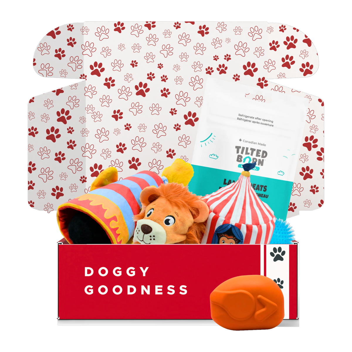 Clowning Around circus dog box with circus cannon and tent plush toys, Tilted Barn Lamb treats and an orange SodaPup roasted turkey