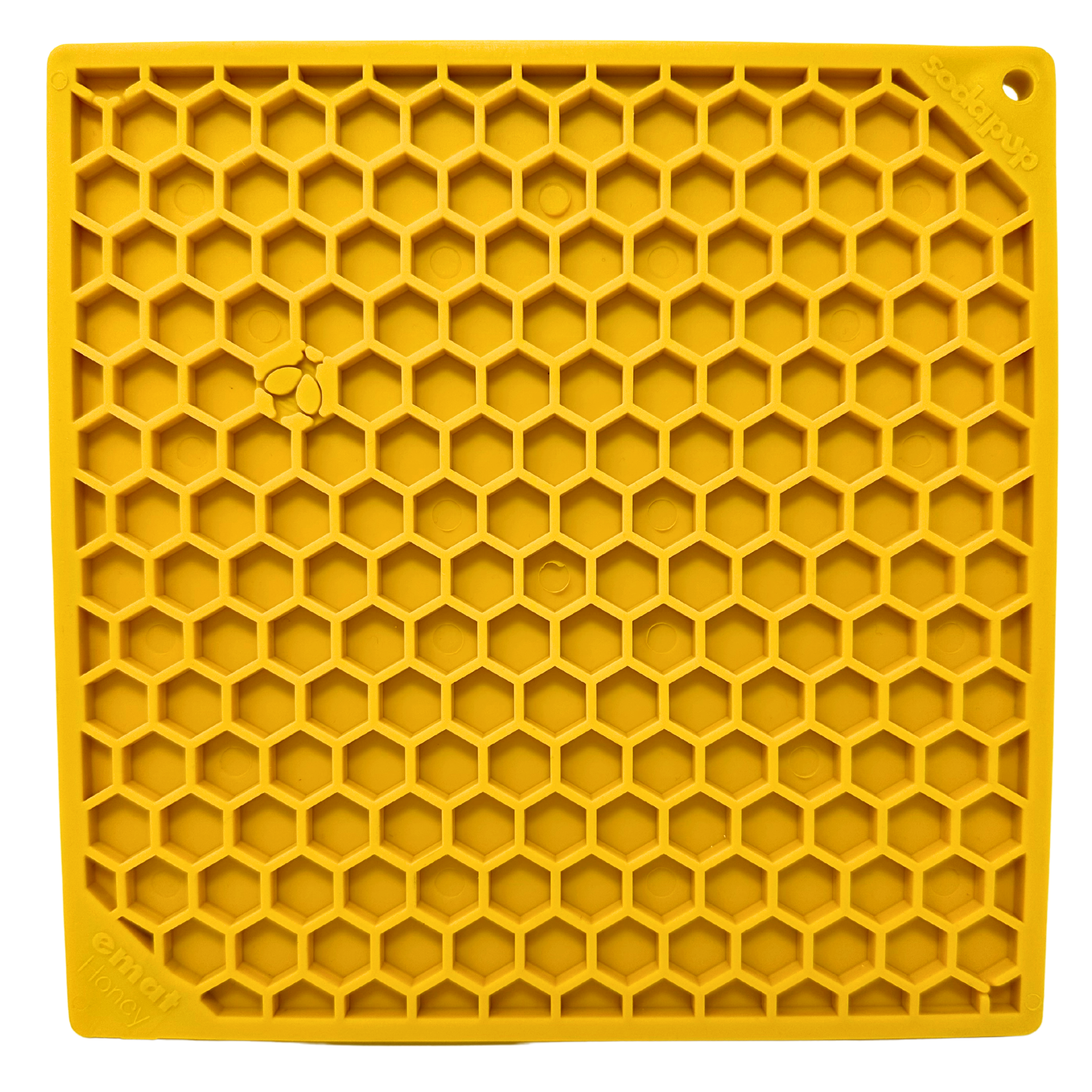 Yellow lick mat with raised honeycomb pattern and the word 'honey' embossed in the corner