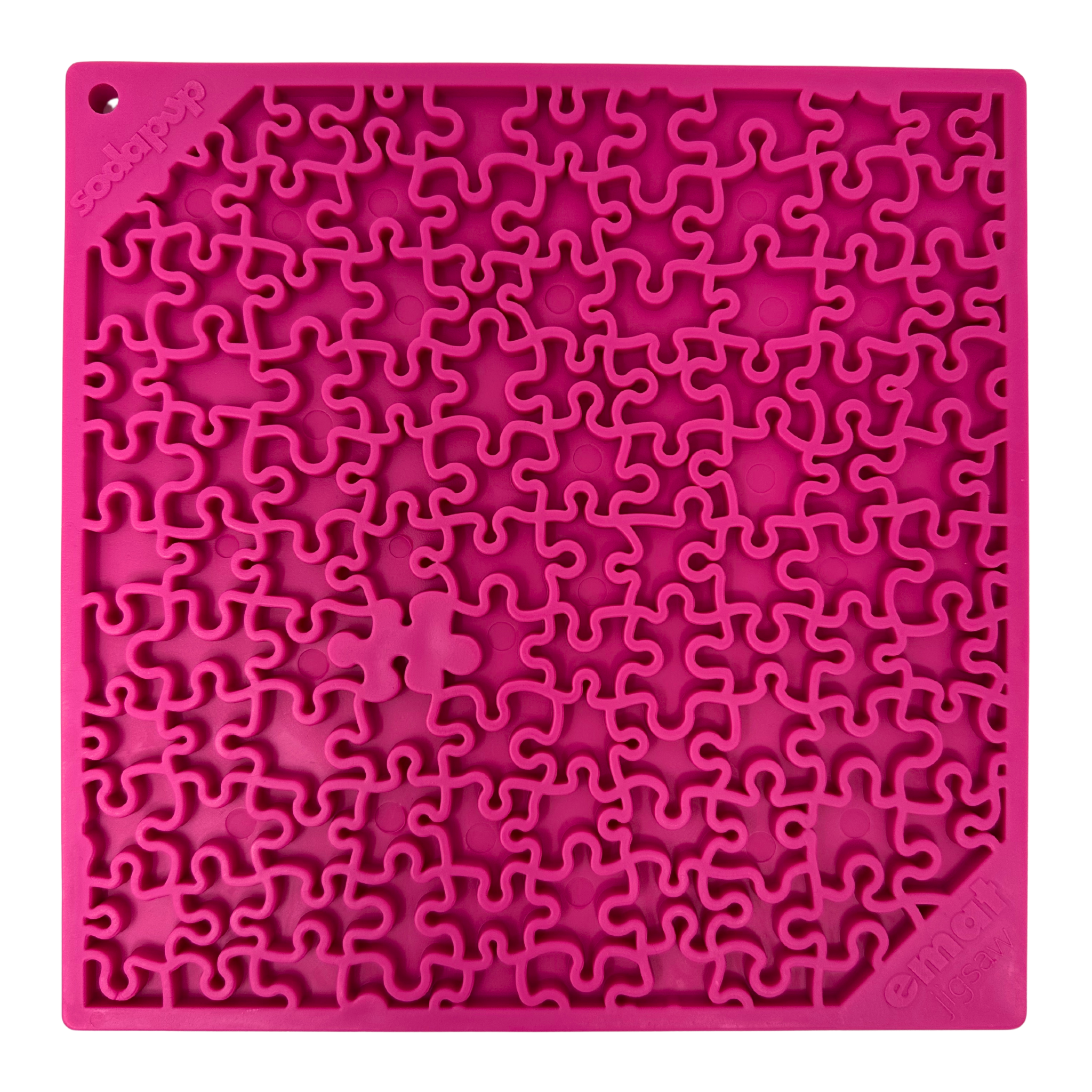 Close-up of a pink dog lick mat with a detailed jigsaw puzzle pattern