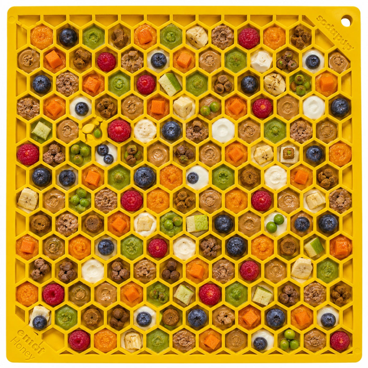 Yellow Honeycomb lick mat with colourful treats in each cell