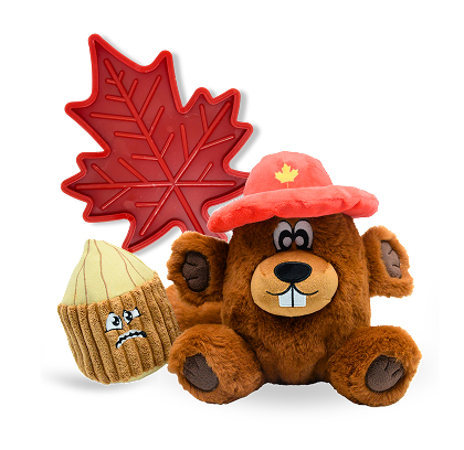 Plush beaver with red maple leaf hat and angry nut toy next to a red maple leaf