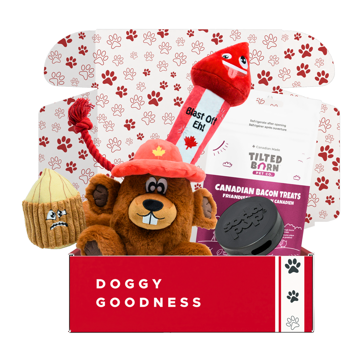 Mounties Mutt Canada dog box with beaver and firework rocket plush toys, Tilted Barn Canadian Bacon treats and a SodaPup hockey puck
