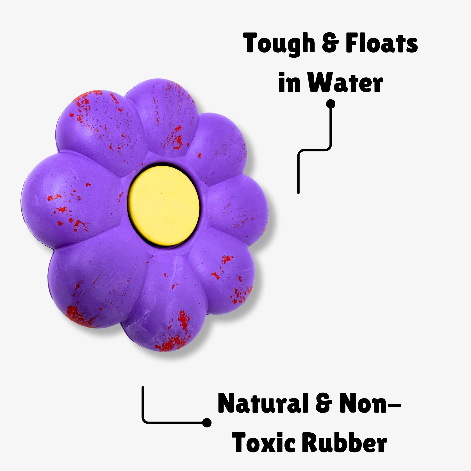 Dog toy shaped like a purple flower, labeled “Tough & Floats in Water” and “Natural & Non-Toxic Rubber”
