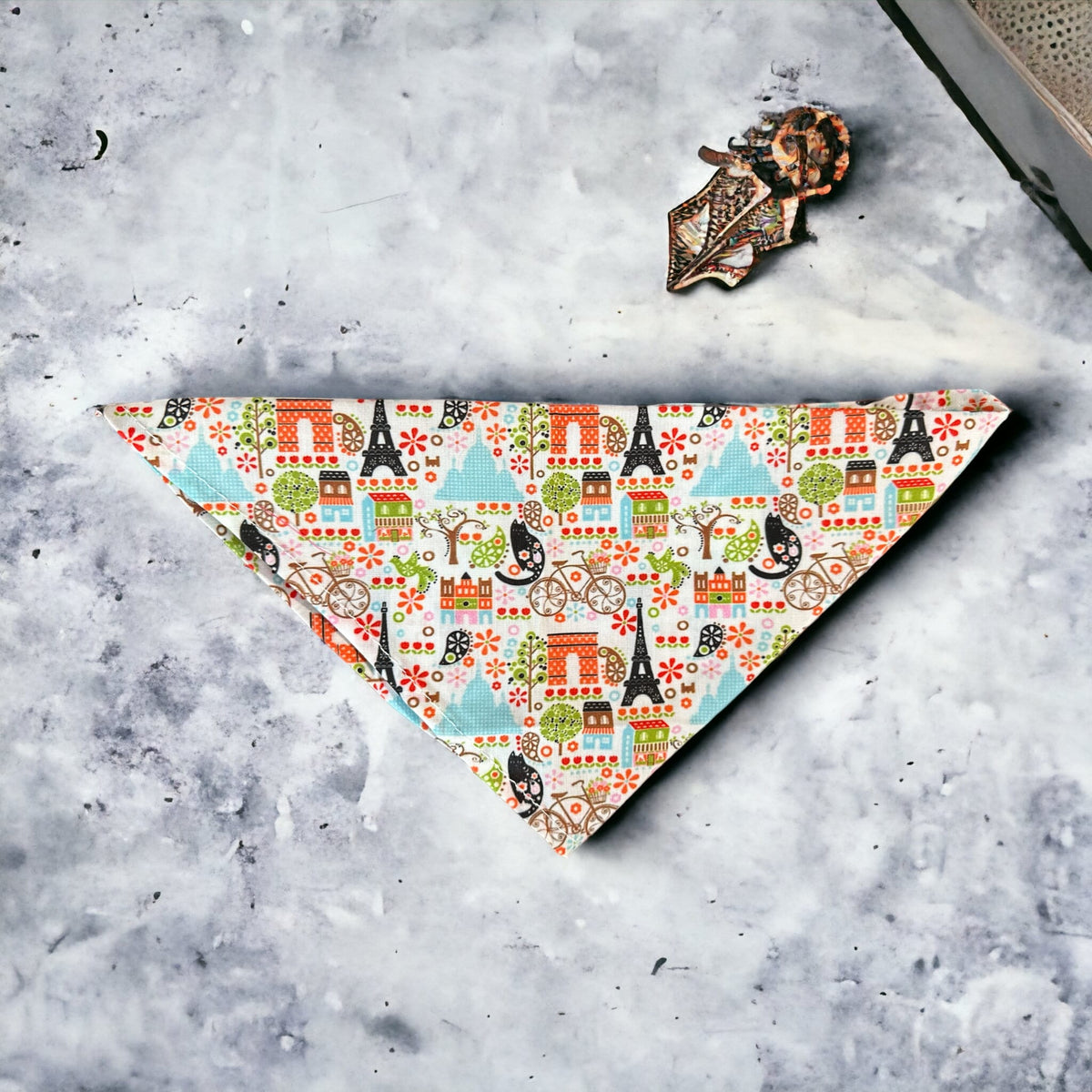 Paris themed dog bandana on a  white marble countertop