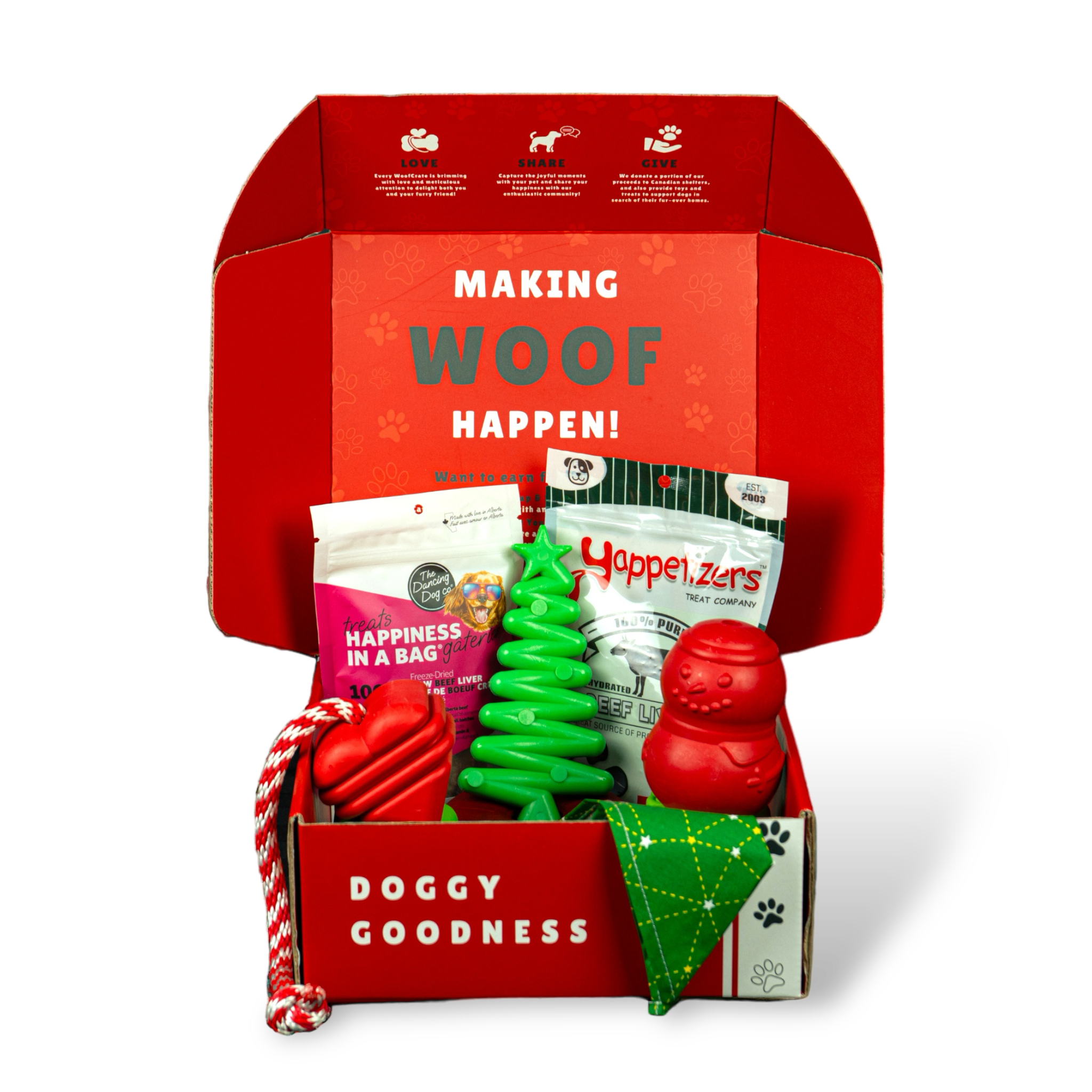 Open red dog box with 2 treat packs, red rope and chew toys, green tree toy and bandana under ‘Making WOOF Happen!’ lid