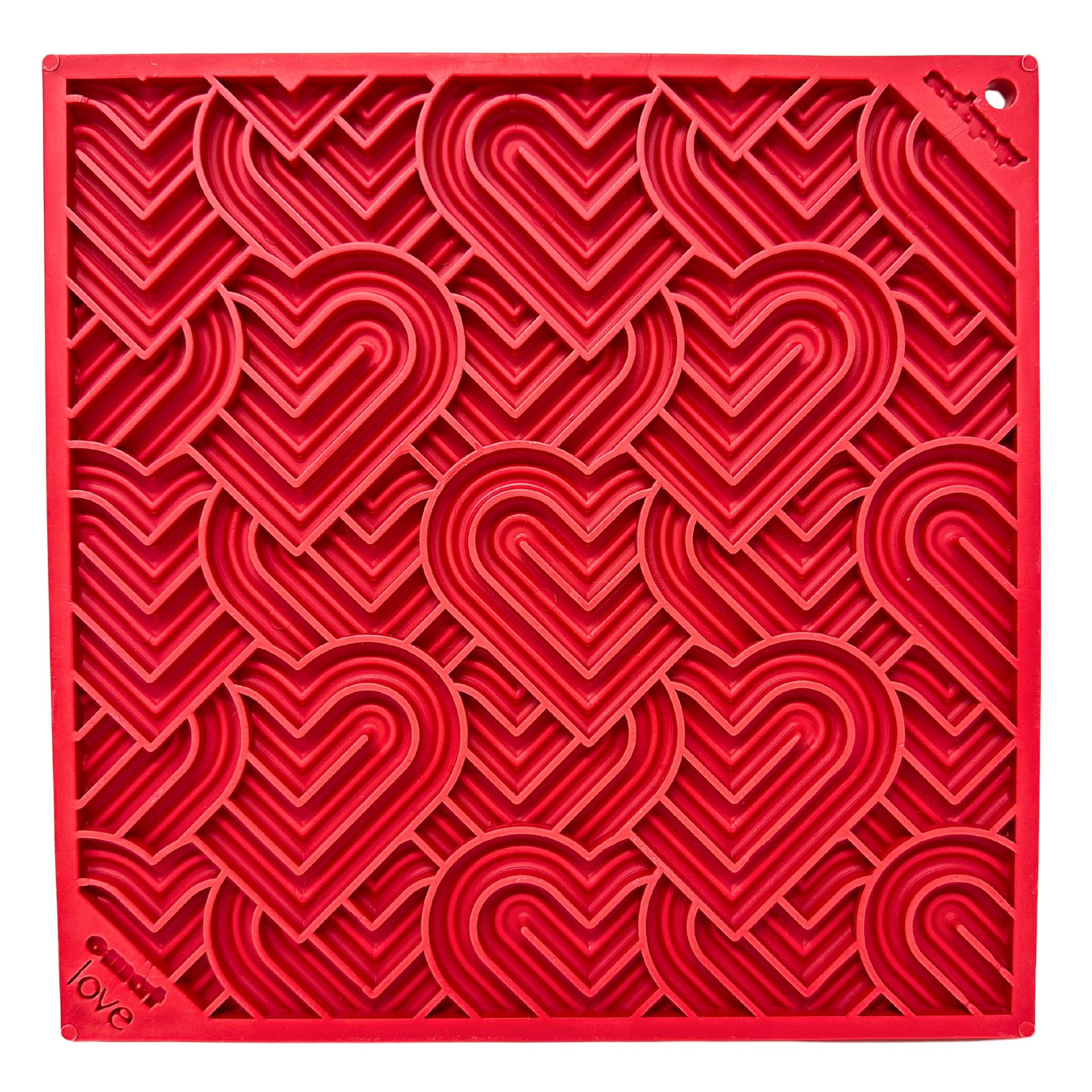 Red lick mat with a raised heart pattern and “love” embossed in the corner